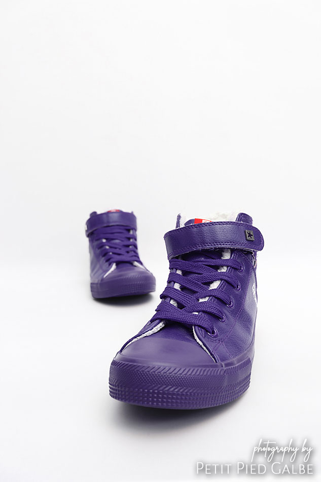 Front view of high top violet sneakers on white background.