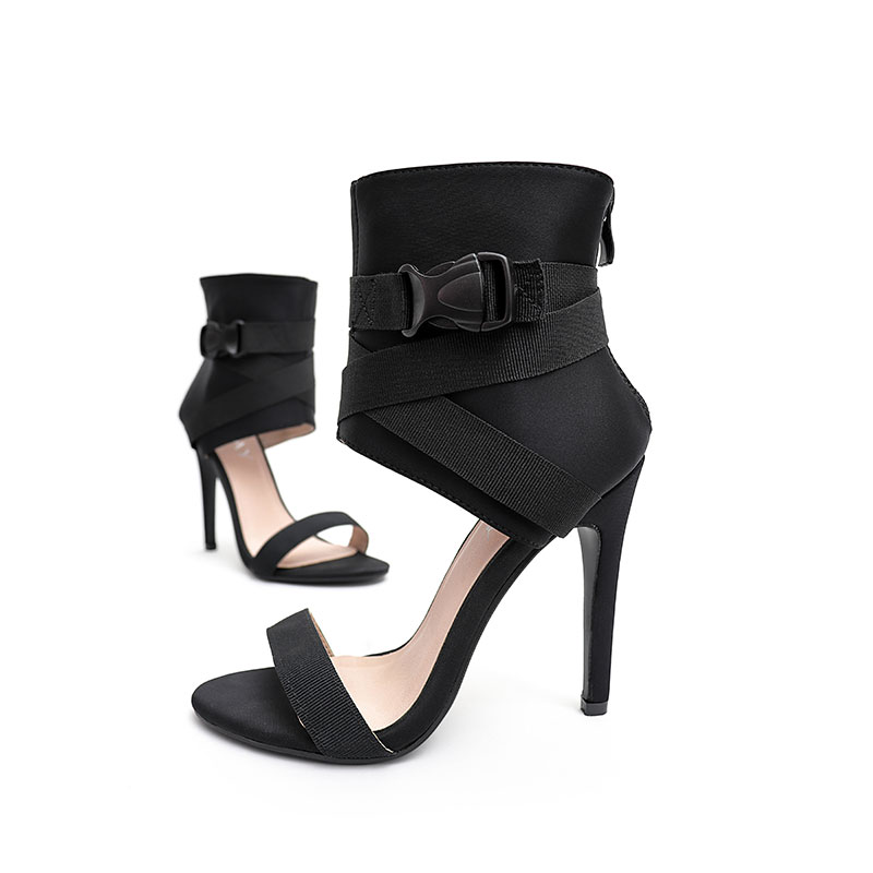 Black high-top stiletto sandals shown from the side on a white background.